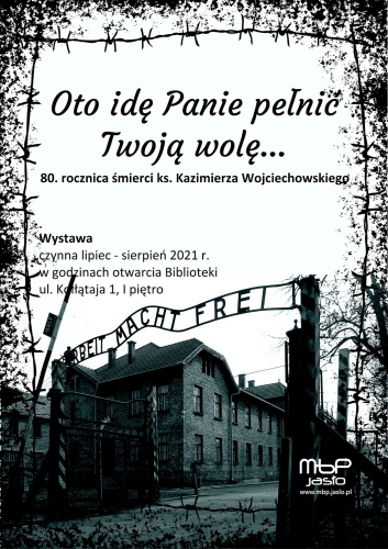 Zdjęcie bramy obozu zagłady Auschwitz z niemieckim napisem Arbeit macht frei 